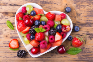 Fruit salad in heart shaped bowl - healthy eating